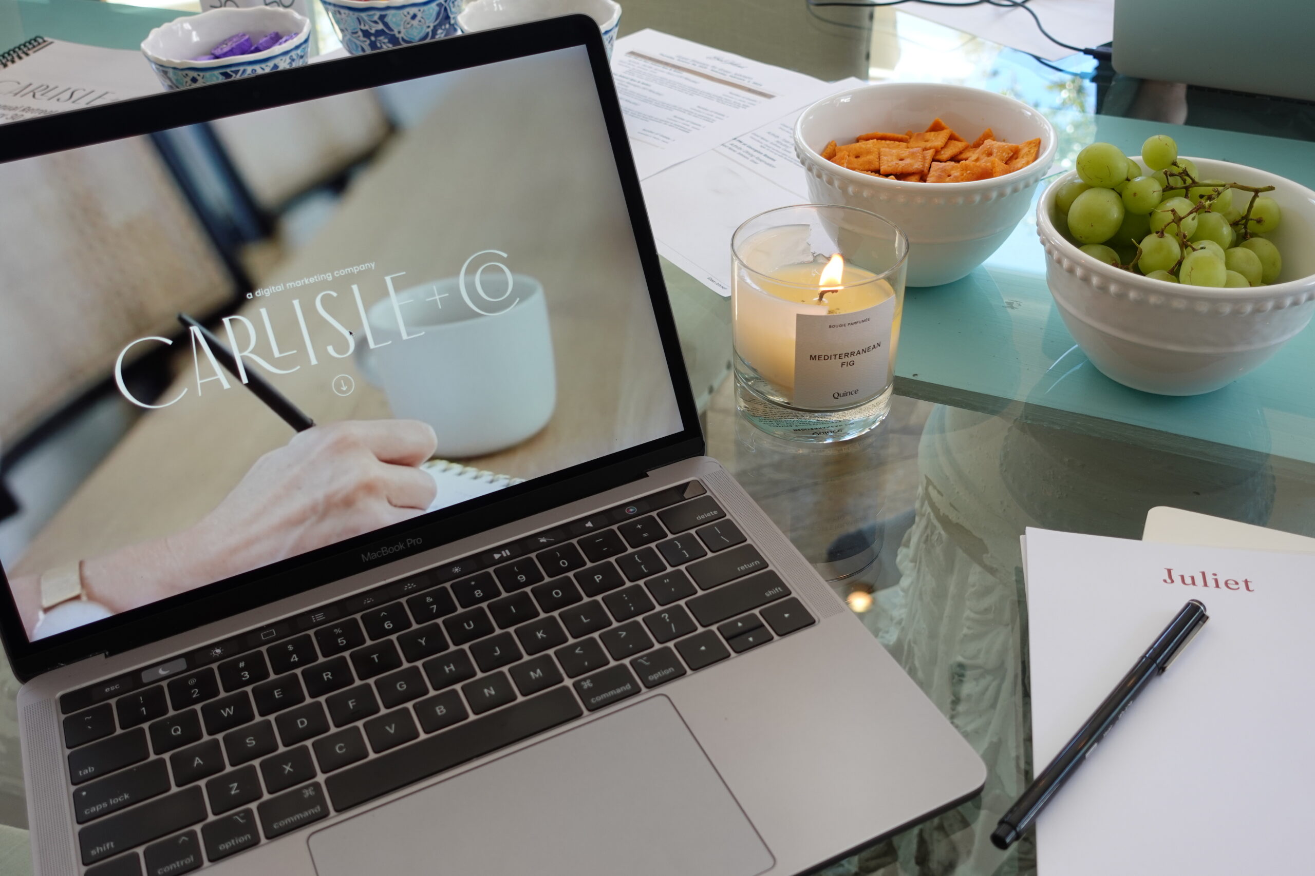 laptop with candle and snacks | carlisledigitalmarketing.com