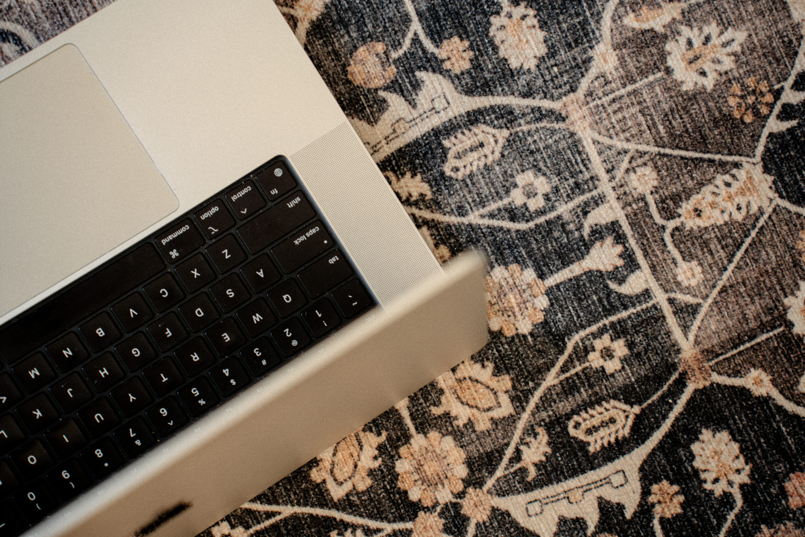 laptop on a navy floral rug | carlisledigitalmarketing.com