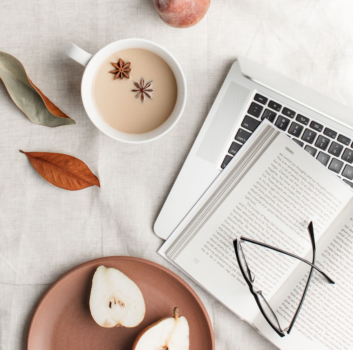 fall foliage cup of coffee keyboard notebook and glasses