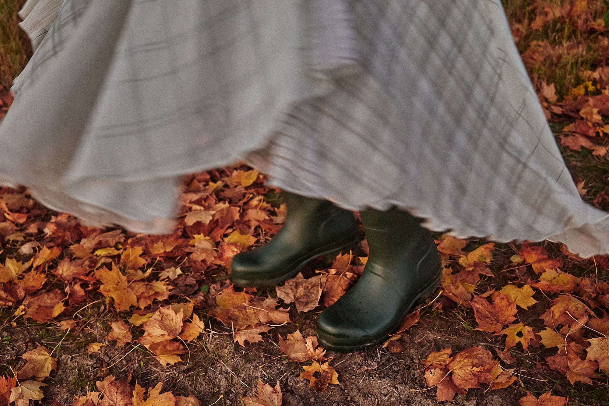 green rain boots and fall leaves